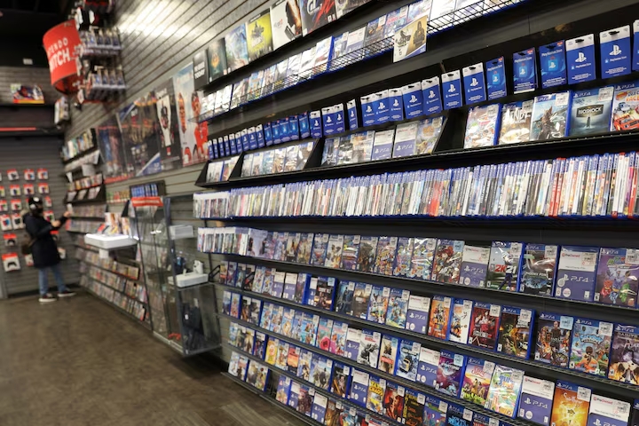 A shopper browses games at a GameStop store in Manhattan, New York, on December 7, 2021. 

Image Source: Reuters 